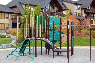 a playground with a slide in front of a house at Luxury Canmore Vacations in Canmore