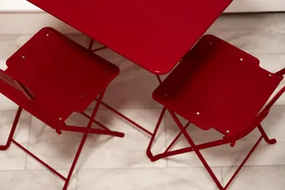 two red chairs sitting under a red table at Retro-Chic Hideaway - Walking Distance To Stampede in Calgary