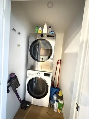 a washer and dryer in a small room at Luxury Downtown One Bedroom with Skyline Views and Free Parking in Edmonton