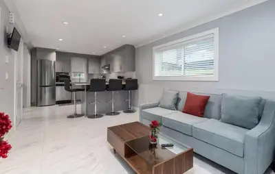 a living room with a couch and a table at Large 3 Bedroom Laneway House in Vancouver