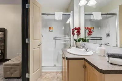 a bathroom with a sink and a shower at Heated Outdoor Pool Near Banff Park in Canmore