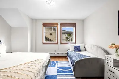 a bedroom with a bed and a couch and a window at 2BR MTN Canmore Retreat with Private Balcony in Canmore