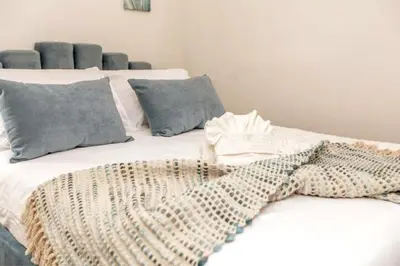 a white bed with a blanket on top of it at 3BDRM Winter Haven - King Beds - Fireplace - Garage in Edmonton