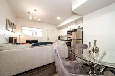 a living room with a couch and a glass table at 3BDRM Winter Haven - King Beds - Fireplace - Garage in Edmonton