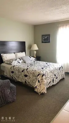 a bedroom with a large bed and a window at Eagles Nest Lodging in Hinton