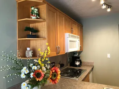 a kitchen with a counter with a vase of flowers at Eagles Nest Lodging in Hinton