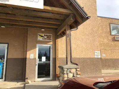 a building with a sign on the side of it at Eagles Nest Lodging in Hinton