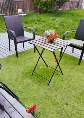 a picnic table and two chairs on a lawn at Beautiful Serenity in Edmonton
