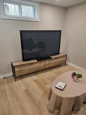 a living room with a large flat screen tv at Beautiful Serenity in Edmonton
