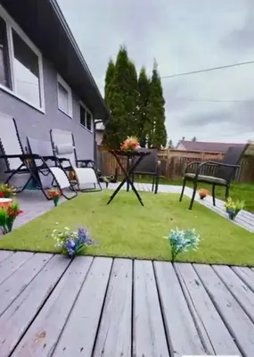 a deck with a table and chairs in a yard at Beautiful Serenity in Edmonton