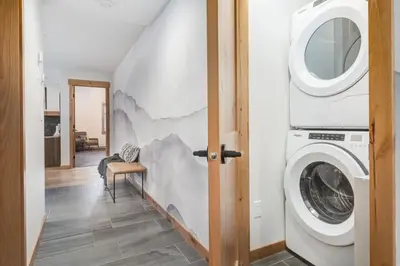 a laundry room with a washer and dryer at Luxury 1750sf Condo In DT Canmore Sleeps 10 in Canmore