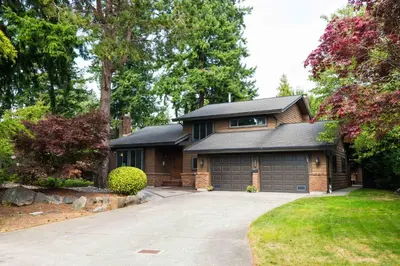 a house with a garage and a driveway at Luxury Home by White Rock in Surrey