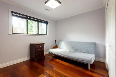 a white room with a bed and a window at Luxury Home by White Rock in Surrey