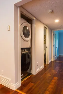 a washer and dryer in a living room at Luxury Home by White Rock in Surrey