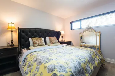 a bedroom with a large bed and a window at Luxury Home by White Rock in Surrey