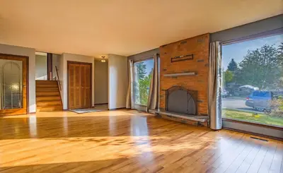 an empty room with a fireplace in a house at All what you need in a House near GrayNuns, Millwoods in Edmonton