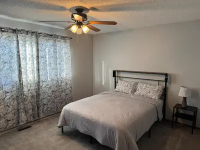 a bedroom with a bed and a ceiling fan at All what you need in a House near GrayNuns, Millwoods in Edmonton