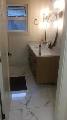 a bathroom with a vanity with a mirror and a sink at Vancouver Downtown Guest House- Walk to Skytrain & BC Place- Free Parking in Vancouver