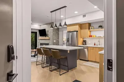 a kitchen with a island with bar stools at King Beds Fire Place New Build in Canmore