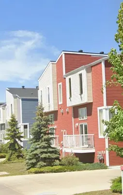 a row of houses with trees in front of them at Private room in Edmonton