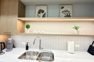 a kitchen with a sink and a counter top at 3 Sisters Mountain Getaway | Luxe 2BR w Pool & Gym in Canmore