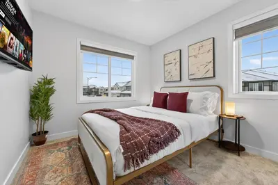 a bedroom with a bed and two windows at luxury Play House Sleeps 12 Keswick in Edmonton