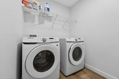 a washing machine and a dryer in a room at luxury Play House Sleeps 12 Keswick in Edmonton