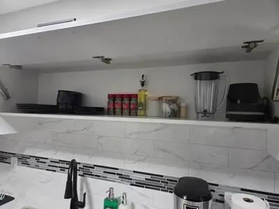 a kitchen with a counter and a counter top with a sink at Cozy Suite Near West Edmonton Mall in Edmonton