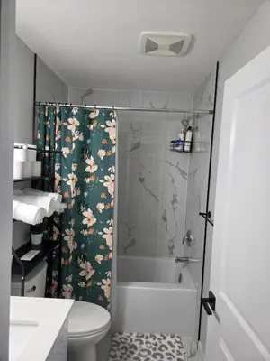 a bathroom with a shower and a toilet and a sink at Cozy Suite Near West Edmonton Mall in Edmonton