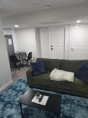 a living room with a couch and a table at Cozy Suite Near West Edmonton Mall in Edmonton