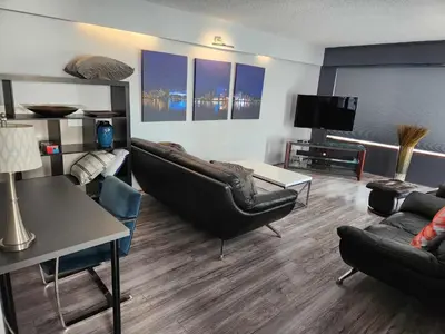 a living room with couches and a flat screen tv at Vancouver house 3 bedrooms and balcony Perfect for your business trip to Vancouver in Vancouver