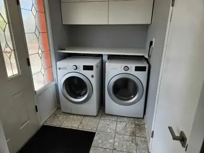 a washer and dryer in a small laundry room at Vancouver house 3 bedrooms and balcony Perfect for your business trip to Vancouver in Vancouver