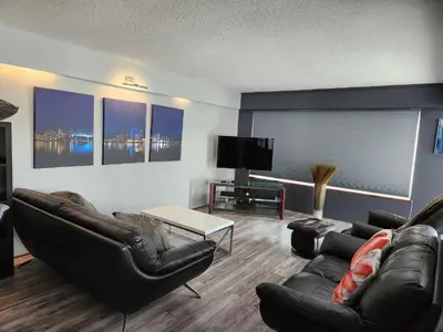 a living room with leather furniture and a flat screen tv at Vancouver house 3 bedrooms and balcony Perfect for your business trip to Vancouver in Vancouver