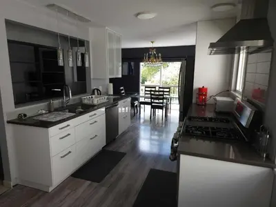 a kitchen with black and white appliances and a table at Vancouver house 3 bedrooms and balcony Perfect for your business trip to Vancouver in Vancouver