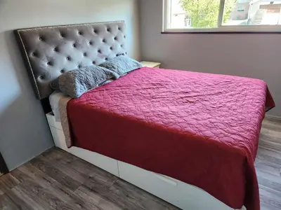 a bedroom with a large bed with a red blanket at Vancouver house 3 bedrooms and balcony Perfect for your business trip to Vancouver in Vancouver