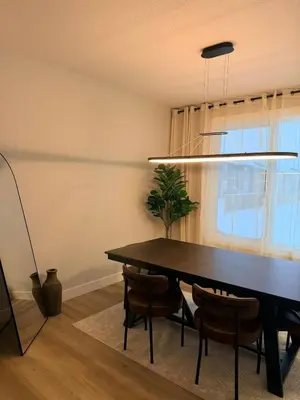 a dining room with a black table and chairs at Cozy and Family-friendly Newly built 3BR Home in Chestermere