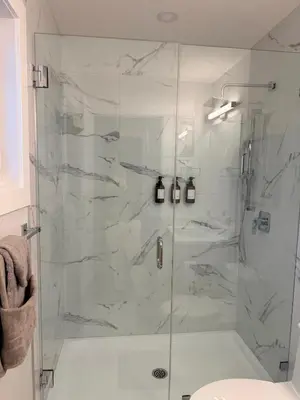 a bathroom with a shower with a glass door at Cozy and Family-friendly Newly built 3BR Home in Chestermere