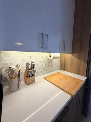 a kitchen with a white counter top with a chopping board at Cozy and Family-friendly Newly built 3BR Home in Chestermere