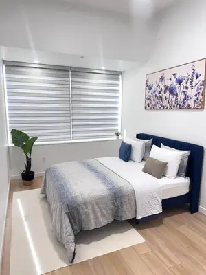 a bedroom with a large bed with a window at Cozy 1-Bedroom with Natural lights in Edmonton