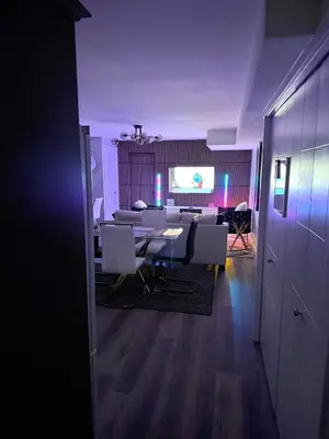 a room with a table and chairs and a projection screen at True Haven Deluxe in Prince George