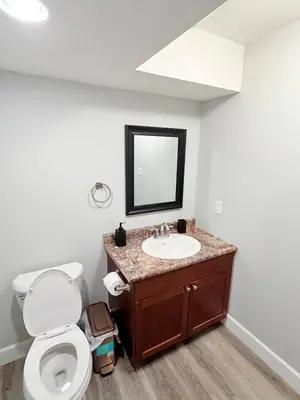 a bathroom with a toilet and a sink at True Haven Deluxe in Prince George