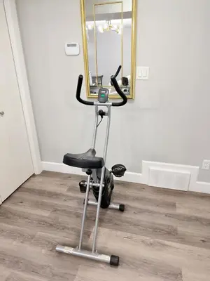 a barber chair in front of a mirror at True Haven Deluxe in Prince George