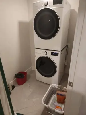 a washer and dryer in a small room at Vancouver Family Condo 2 Bedrooms 2 Baths Near UBC & Parks in Vancouver