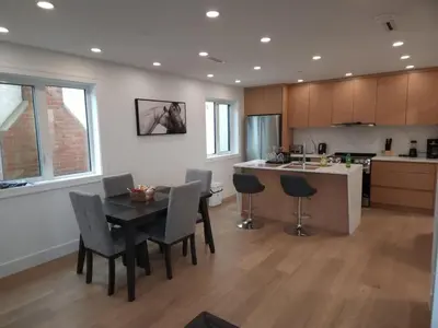 a kitchen and dining room with a table and chairs at Vancouver Townhouse Family-Friendly with Street Parking & Balcony in Vancouver