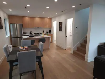 a kitchen and living room with a table and chairs at Vancouver Townhouse Family-Friendly with Street Parking & Balcony in Vancouver