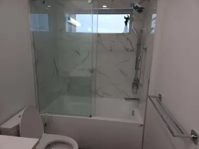 a bathroom with a shower and a toilet with a glass door at Vancouver Townhouse Family-Friendly with Street Parking & Balcony in Vancouver