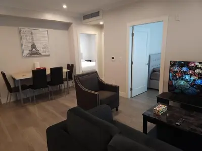 a living room with a couch and a dining room at Vancouver Townhouse 2 Queen Beds Kitchen Street Parking - Perfect for Families in Vancouver