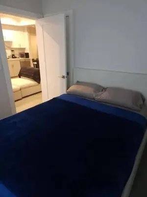 a bedroom with a bed with a blue blanket at Vancouver Townhouse 2 Queen Beds Kitchen Street Parking - Perfect for Families in Vancouver