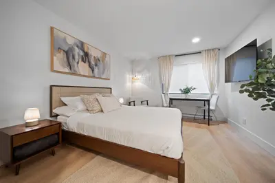 a bedroom with a bed and a desk in it at The Alpine Alcove w Pool & Hot Tub in Whistler