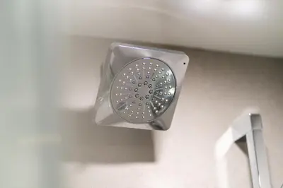 a shower head on the wall of a bathroom at The Alpine Alcove w Pool & Hot Tub in Whistler